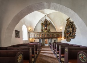 Pews and organ in Gothic interior with decorative details, 14th century church, Old Town,