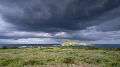 Coast and dark storm clouds near Port de Centuri, Cap Corse, Haute-Corse, Corsica, France