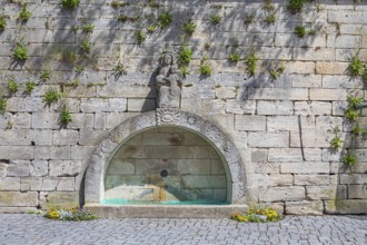 Town wall with a fountain on Marienplatz in Kronach, Germany