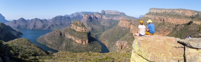 Two hikers enjoying panorama, Blyde River Canyon with Three Rondawels peak, view of gorge with