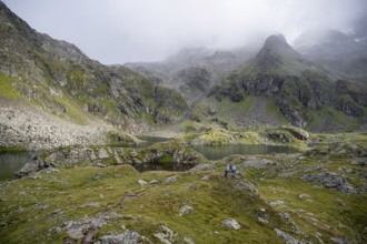 Two female mountaineers in a cloudy mountain landscape, Kreuzsee mountain lake, Wiener Höhenweg,