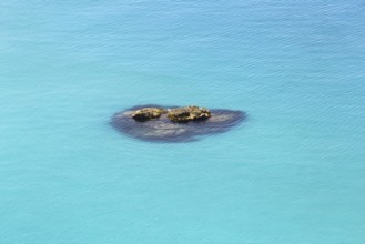 Small group of rocks in the turquoise-coloured sea with calm water, Ricadi, Capo Vaticano
