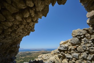 View through a ruined opening onto a landscape with blue sky, Abandoned Village, Lost Place, Pyli,