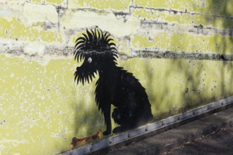 Black dog with bone, funny mural at Cologne Zoo car park, graffiti, Cologne, North