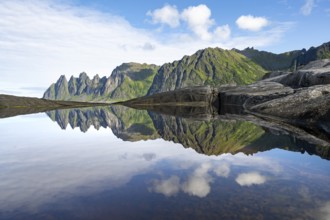 Reflection in a tidal pool, rocky coast of Tungeneset, Devil's Teeth, Okshornan, Ersfjorden, Senja
