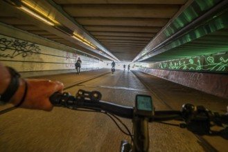 Ride your bike through the tunnel under the tracks of Utrecht Central, HBF, on the central cycle