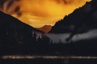 Surreal light atmosphere at sunrise at Plansee, Tyrol, in the Alps in Austria