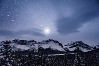 Starry sky during a winter road trip on the Icefields Parkway with lots of snow and ice, Banff
