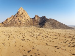 The isolated Spitzkoppe mountain (1728 m) majestically rises above the surrounding desert plains.