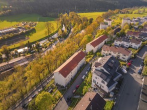 Terraced houses in a rural urban landscape with streets and spring-like trees, Nagold, Calw