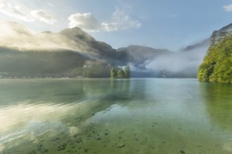 Mystical morning at Königssee in Schönau with boathouses and Christlieger. Sunrise and beautiful