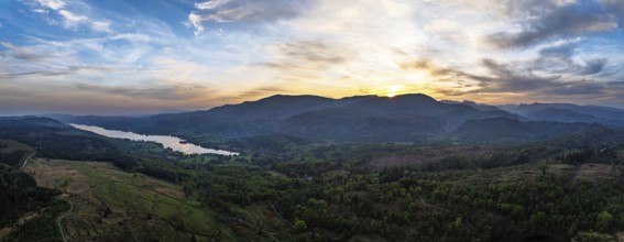 Panorama of Sunset over Mountains and Coniston Water from drone, Lake District National Park,