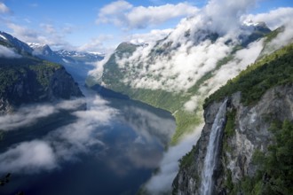 Gjerdefossen waterfall, at Ørnesvingen viewpoint, atmospheric clouds over the fjord in the morning