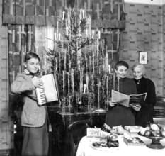 Young-mother-grandmother-Christmas, 1940s, Three generations celebrate Christmas next to a festive