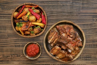 Succulent short beef ribs roasted in the oven served alongside a medley of grilled vegetables and a