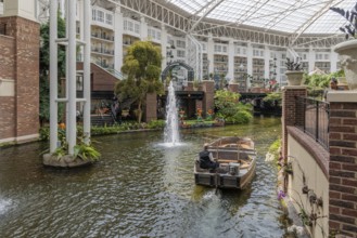 Guide piloting boat through the canal inside the Gaylord Opryland Resort and Convention Center in