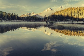 Lake Staz near Sankt Moritz in the Engadin in Switzerland. Morning atmosphere with fog in autumn.