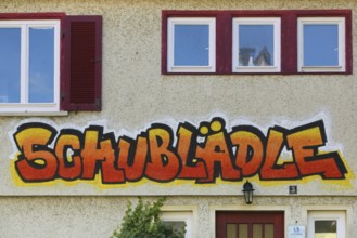 Clothes shop and meeting café Schublädle, mural, house facade, writing, social project, second-hand