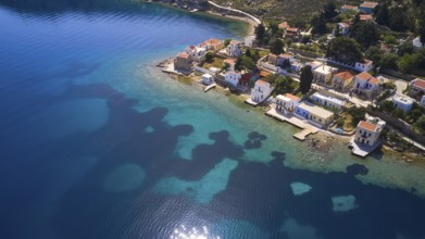 Drone shot, coastal village with white houses on the blue sea and clear coastal landscape, Bay of