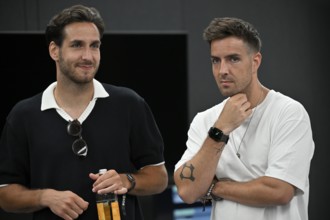 Joshua Keller (left) in discussion with brother Aaron Keller, sons of actor Mark Keller, tennis,