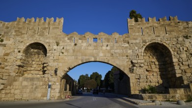 Arsenal Tor, Rhodes city wall, Medieval stone gate with symmetrical arches over the street, harbour