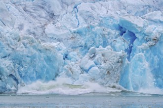 Collapsing ice wall of Fjortende Julibreen, 14th of July Glacier calving into Krossfjorden, Haakon