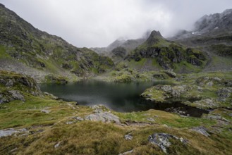 Mountain lake Kreuzsee, cloudy mountain peaks, Schober group, Hohe Tauern National Park, Carinthia,