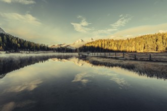 Lake Staz near Sankt Moritz in the Engadin in Switzerland. Morning atmosphere with fog in autumn.