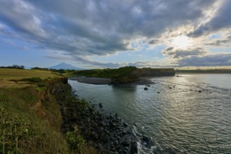 Coastal landscape with sea, cliffs and cloudy sky, calming atmosphere, Opunake, Egmont Volcano,