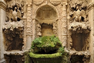 Ornamental fountain from the Renaissance, fountain with moss and artificial dripstone from the
