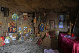 Cave with religious icons and altar table, spiritual atmosphere, chapel, Agios Nikolaos, rock