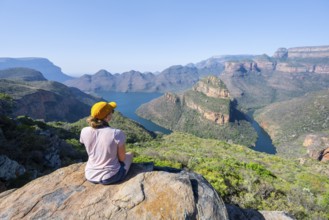 Hiker enjoying panorama, Blyde River Canyon with summit Three Rondawels, view of canyon with river