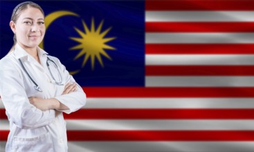 Female doctor on Malaysia flag. Doctor with crossed arms on Malaysia flag. Malaysia health and care