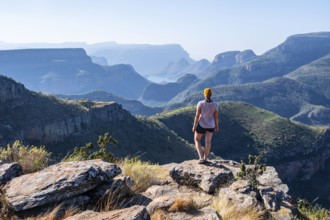 Tourist looking over canyon landscape, view of Blyde River gorge, Lowveld Viewpoint, in the evening