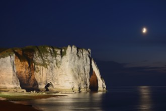 Cliffs with the Falaise d'Aval rock gate and the Aiguille rock needle at night, Etretat, Alabaster
