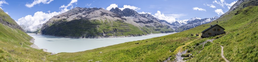 Panorama, blue mountain lake and alpine hut in mountain landscape, Lac des Dix reservoir and Mont