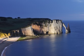 Cliffs with the Falaise d'Aval rock gate and the Aiguille d'Etretat rock needle at night, Etretat,