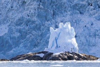 Glacier tongue, block of ice on rock in front of a break-off edge, sea, Fugelfjorden, Spitsbergen,