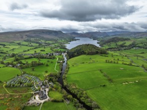 Farms and mountains over Ullswater Lake from drone, Pooley Bridge, Lake District National Park,