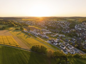 Aerial view of a village with fields and houses in the warm light of sunset, Gechingen, Black