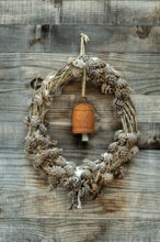 A wreath made of pinecones and natural materials is displayed on a rustic wooden wall. An antique
