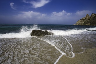 Dynamic wave movement on the beach with splashing spray and rocks, Ricadi, Capo Vaticano