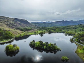 Farms and Mountains over road A591 from a drone, Grasmere Lake, Grasmere, Ambleside, Lake District,