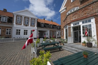 Cosy café with Danish flags and inviting terrace under a blue sky, Old Town, Ringkøbing, Ringkøbing