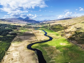 Farms and Mountains over River Dochart and Road A85 from a drone, Perthshire, Scotland, UK
