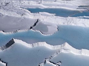Detailed view of the limestone sinter terraces with turquoise-coloured water in Pamukkale, aerial