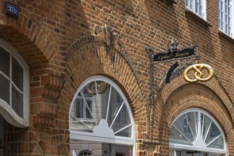 Brick building with bakery and wrought-iron sign, Old Town, Ringkøbing, Ringkøbing Fjord, Denmark