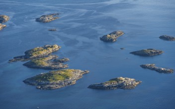 Small rocky islands in the sea, archipelago islands, near Henningsvær, Vågan, Lofoten, Nordland,
