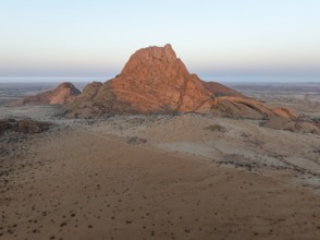 The isolated Spitzkoppe mountain (1728 m) majestically rises above the surrounding desert plains.