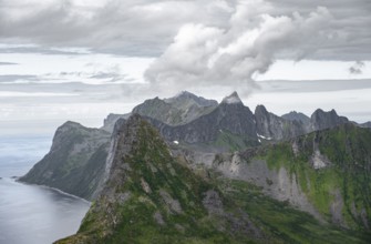 View of mountain peaks on the headland of Fjordgård with peak Segla, fjords Øyfjorden and